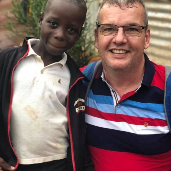 George with boy in Uganda